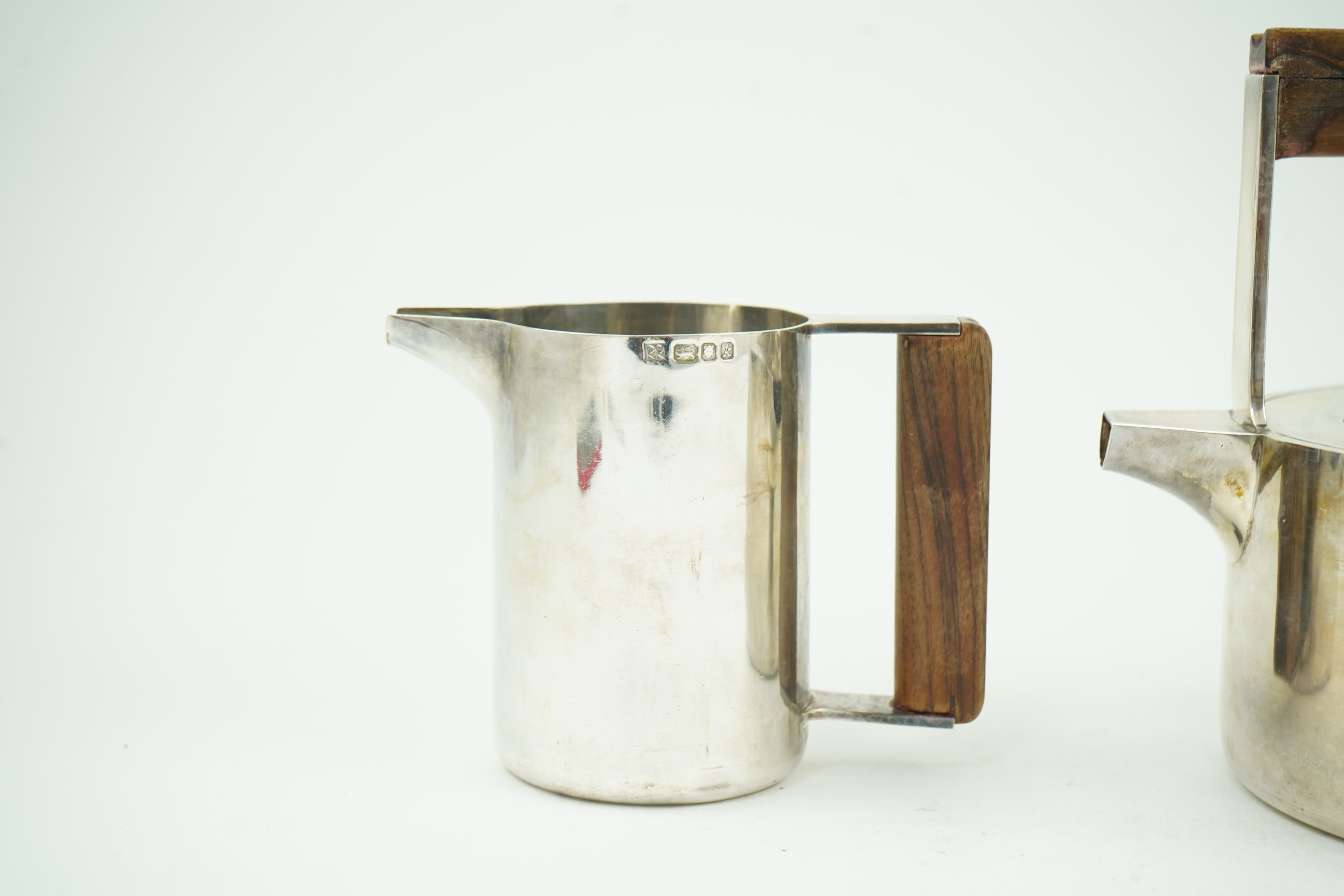Roy Ridsdale (1942-2020): A silver tea kettle and matching cream jug
